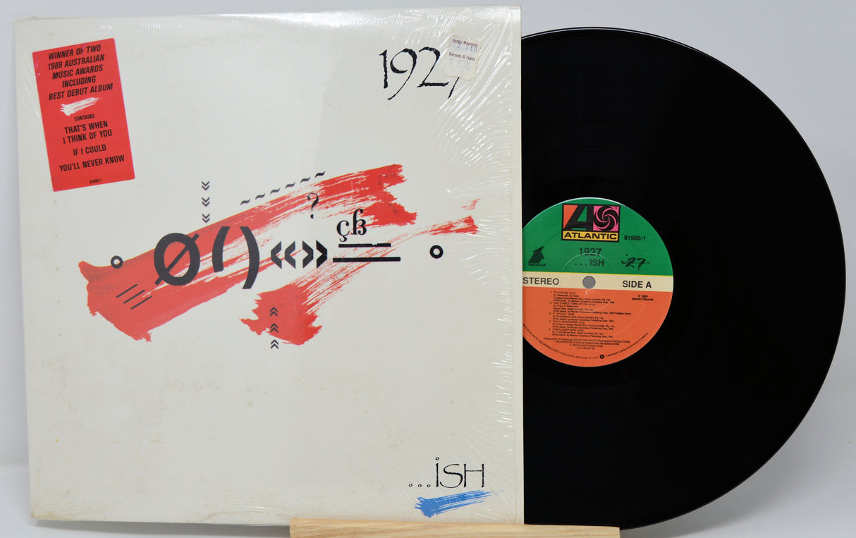 Vinyl record with cover featuring abstract design and text