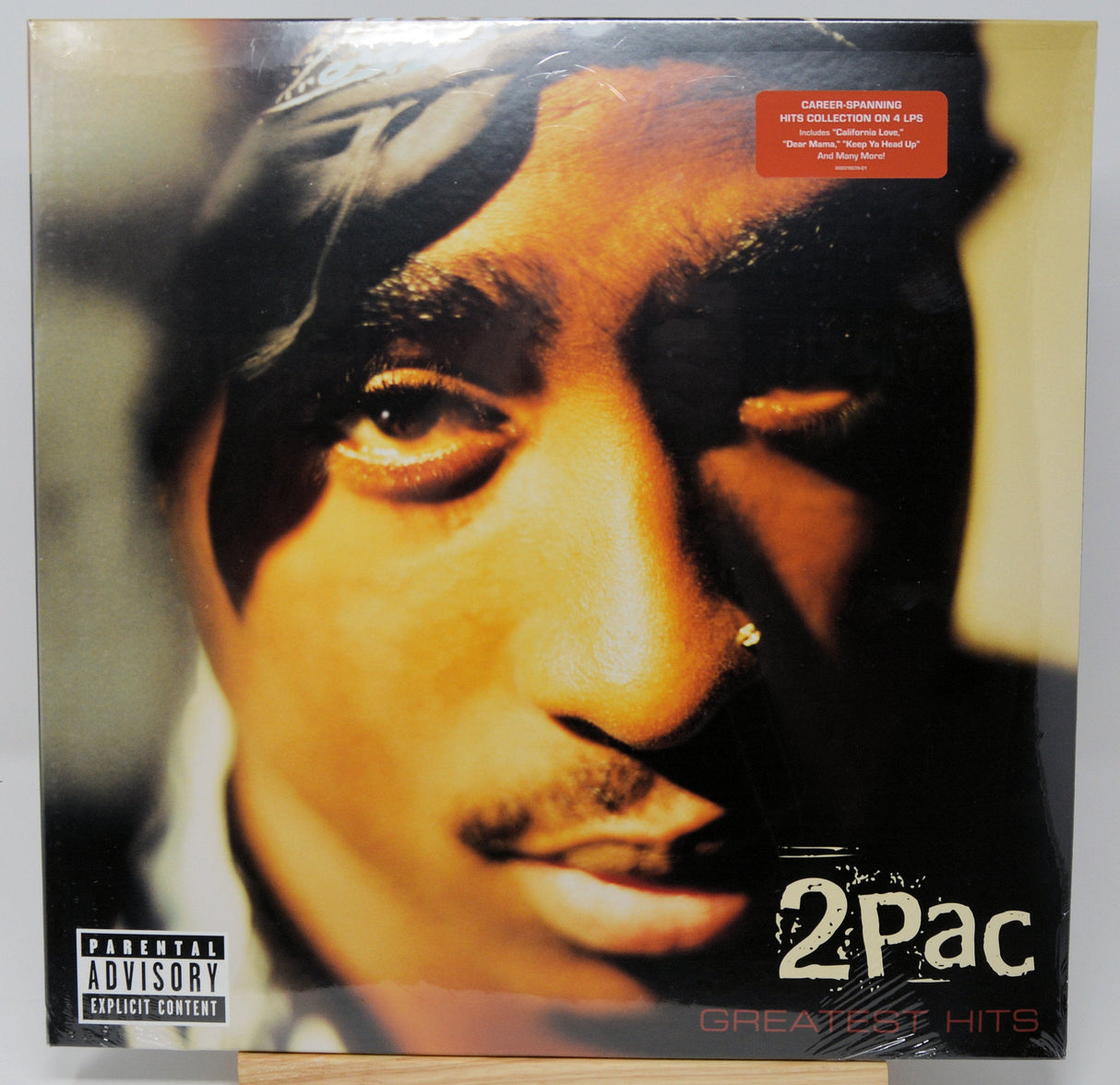 Front cover of 2Pac Greatest Hits vinyl LP featuring a close-up of 2Pac's face with album title