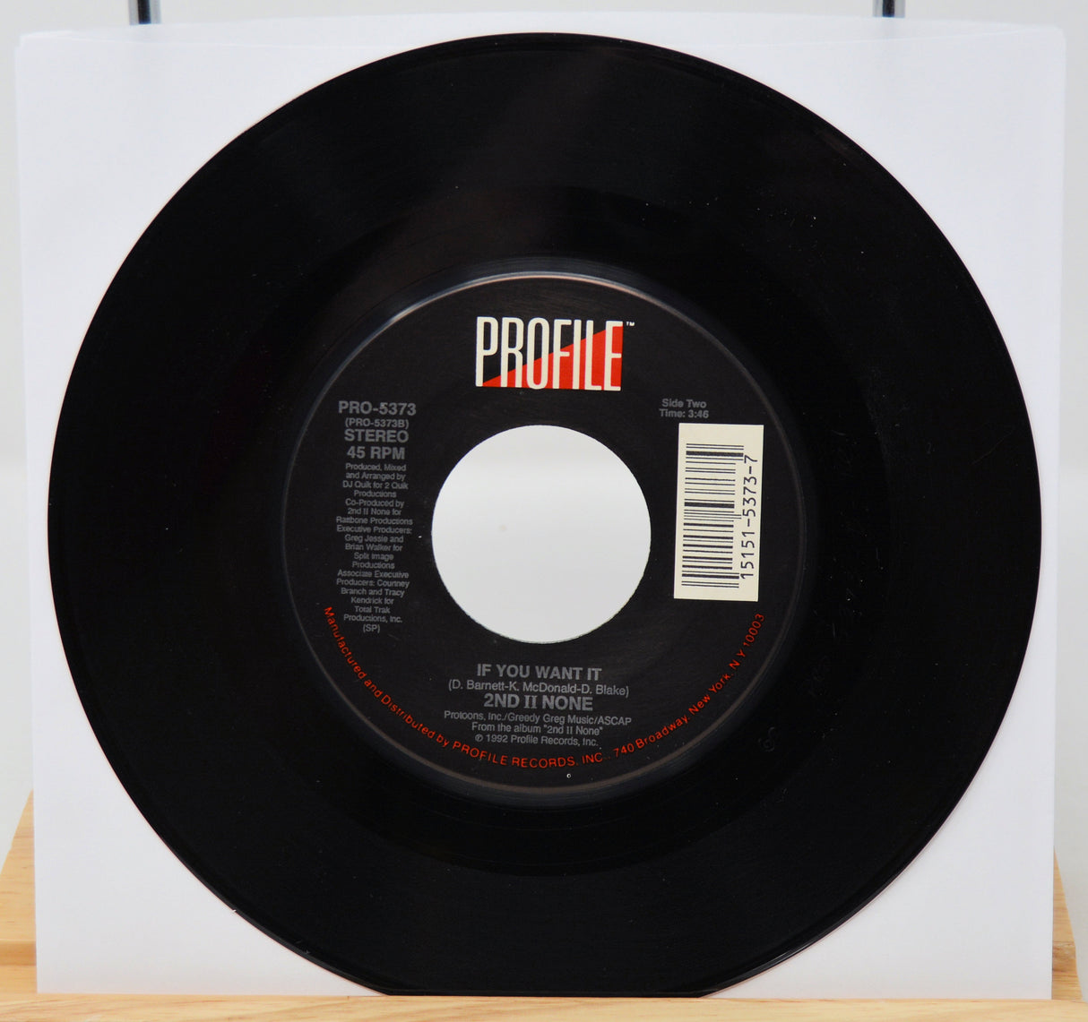 Black vinyl record with 'PROFILE' label on a white background