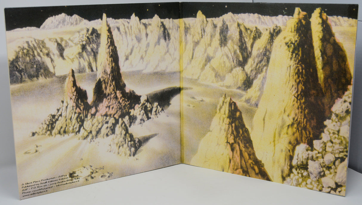 Inner gatefold artwork showing a surreal, mountainous moon-like landscape