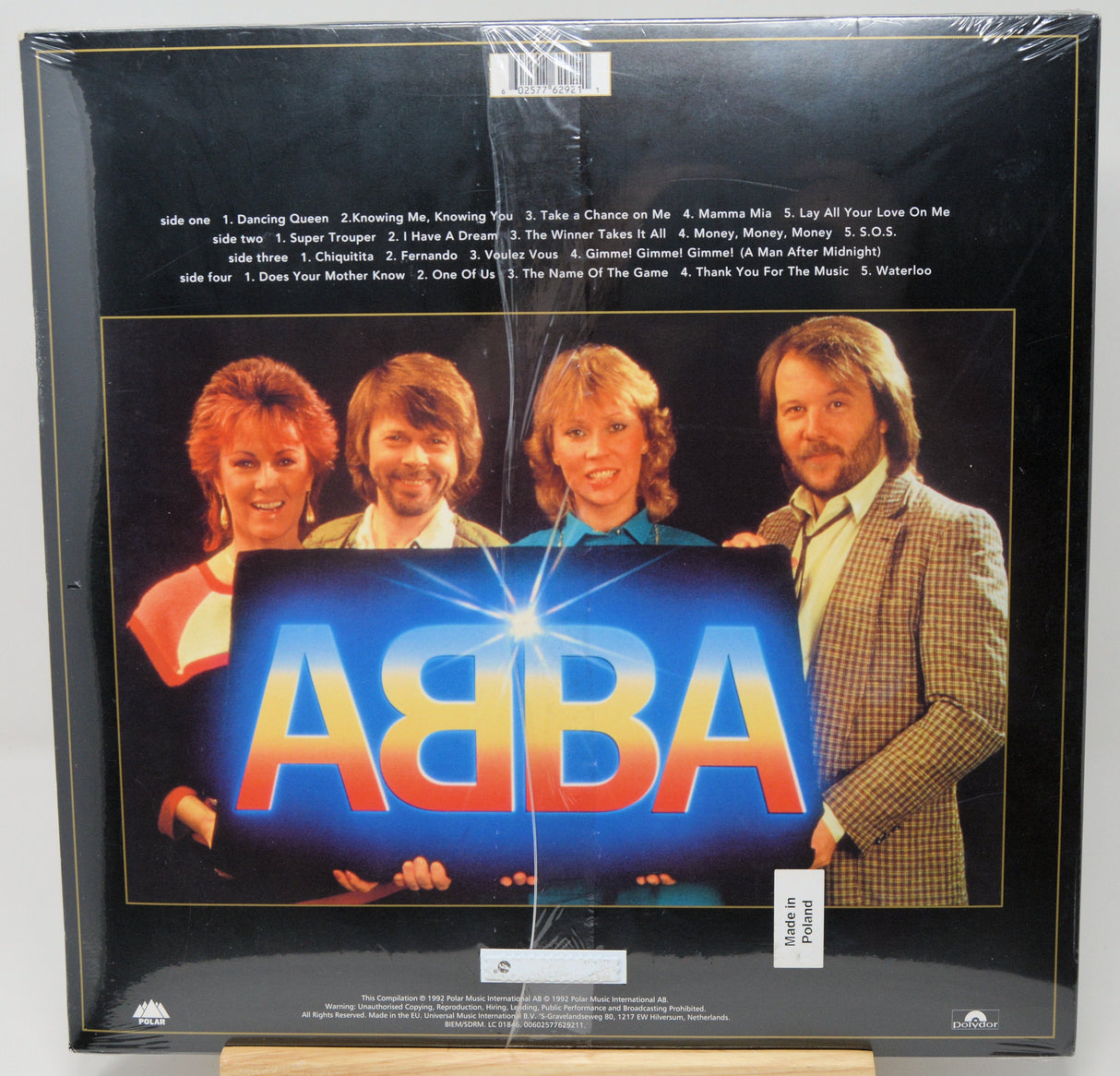 Back cover of ABBA Gold vinyl featuring ABBA members holding a glowing ABBA sign