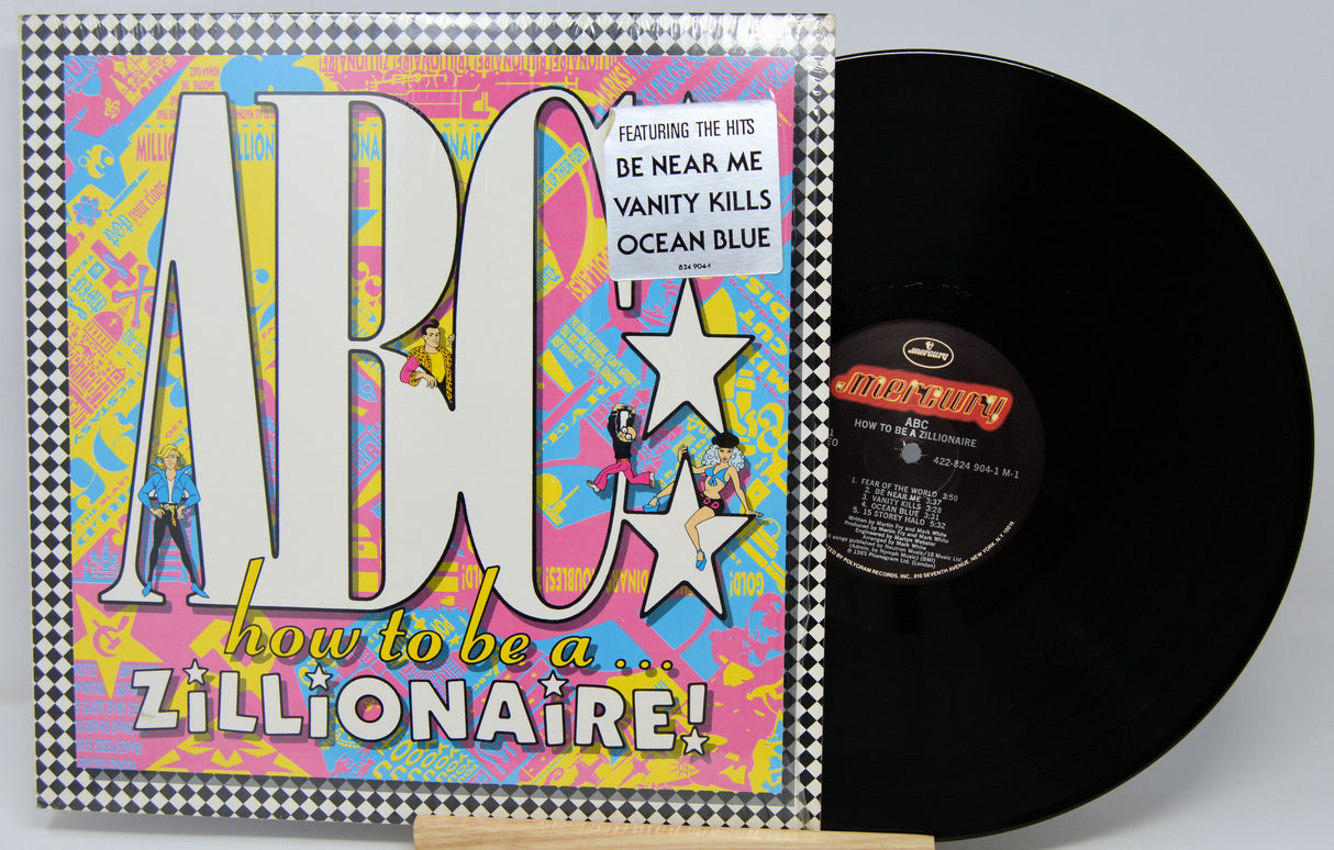 Vinyl record with colorful cover featuring text and graphics on a gray background