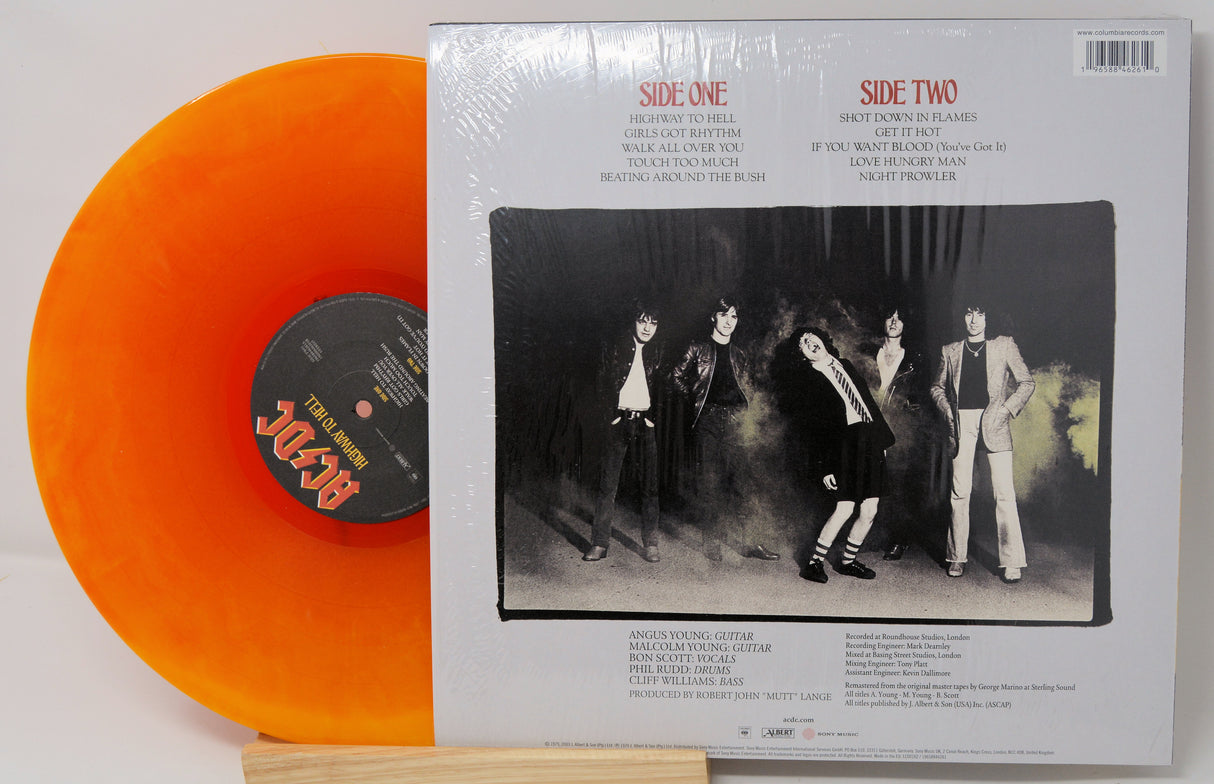 Vinyl record with orange disc and cover featuring a band image.