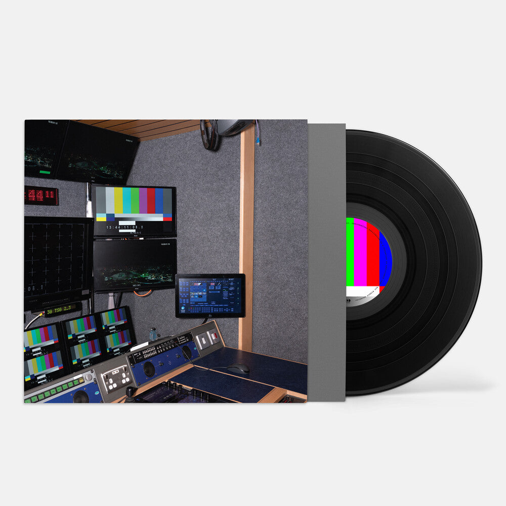 Vinyl record with a color test pattern and a control room background