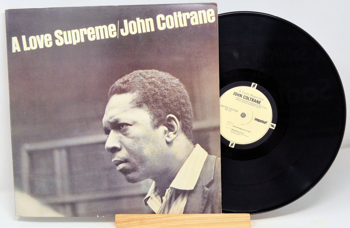 Front cover of John Coltrane's 'A Love Supreme' vinyl with record partially displayed, highlighting the legendary jazz album