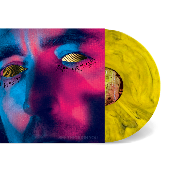 Vinyl record with a colorful cover featuring a face and text, on a white background.