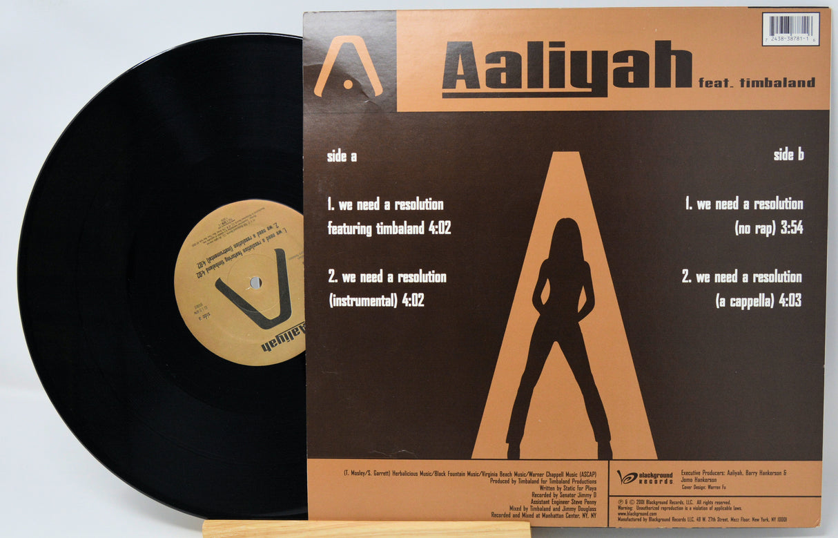 Vinyl record with cover featuring Aaliyah and Timbaland on a white background
