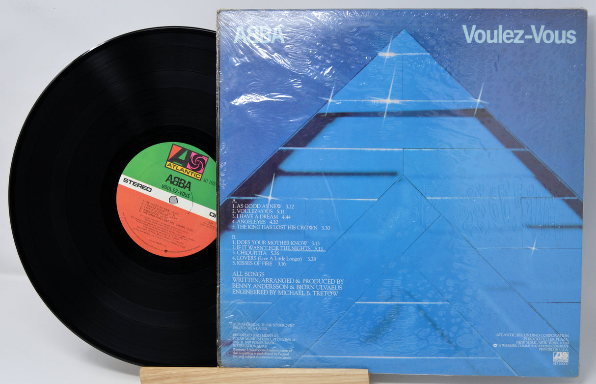 Vinyl record and its cover titled 'Voulez-Vous' by ABBA on a white background.