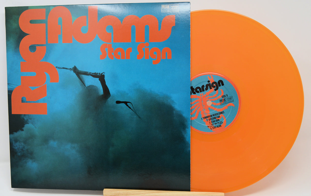 Vinyl record with blue and orange cover featuring 'Ryan Adams Star Sign' text