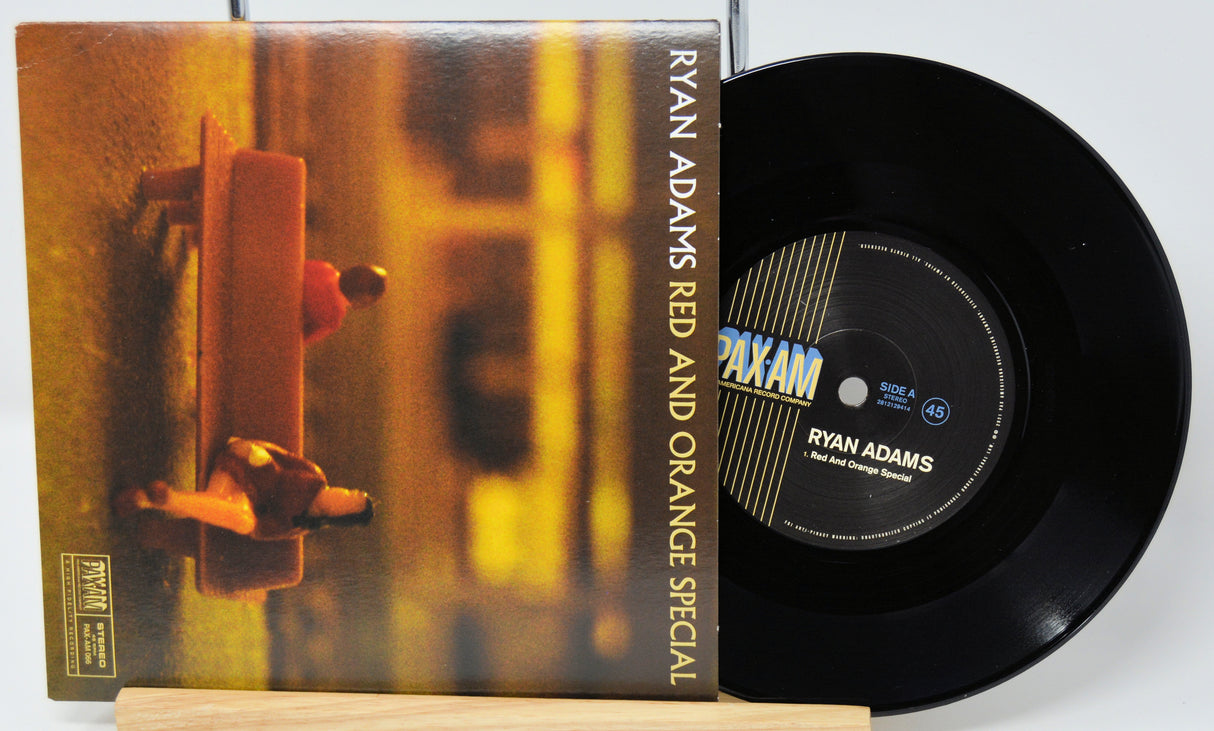 Vinyl record and cover with 'Red and Orange Special' by Ryan Adams on a white background