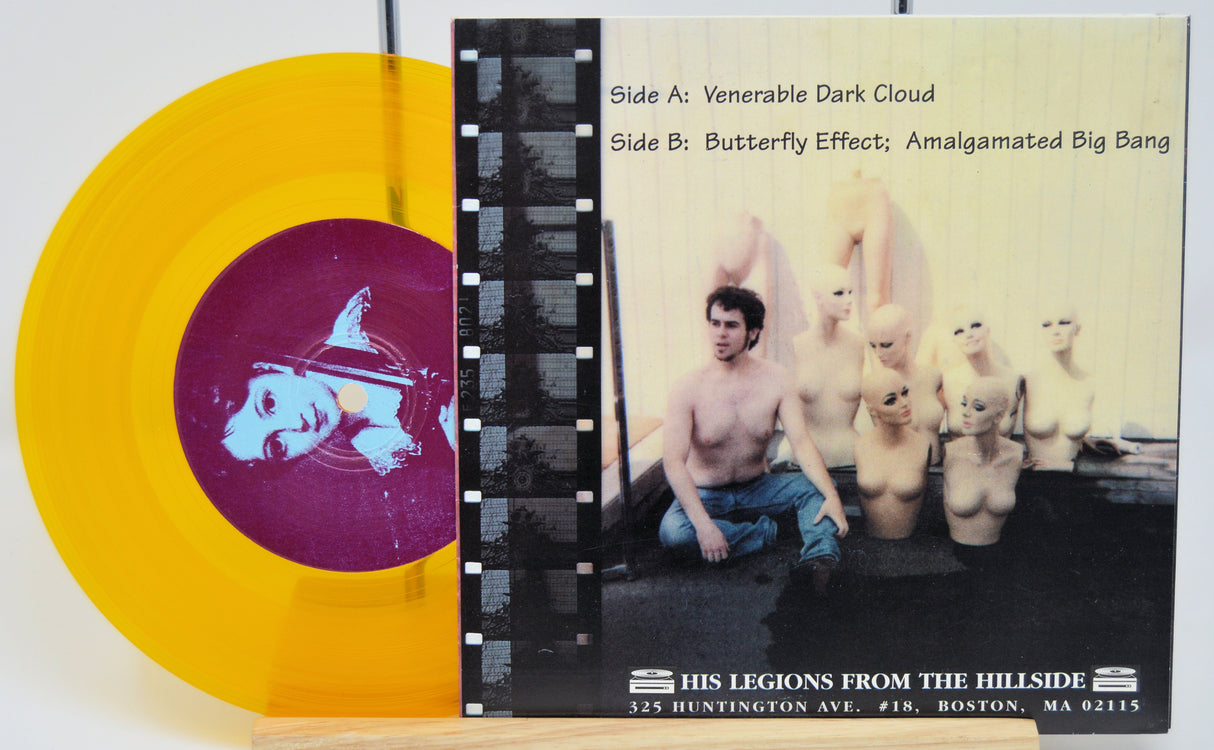 Vinyl record with yellow and purple design and album cover featuring a shirtless man and white figures.