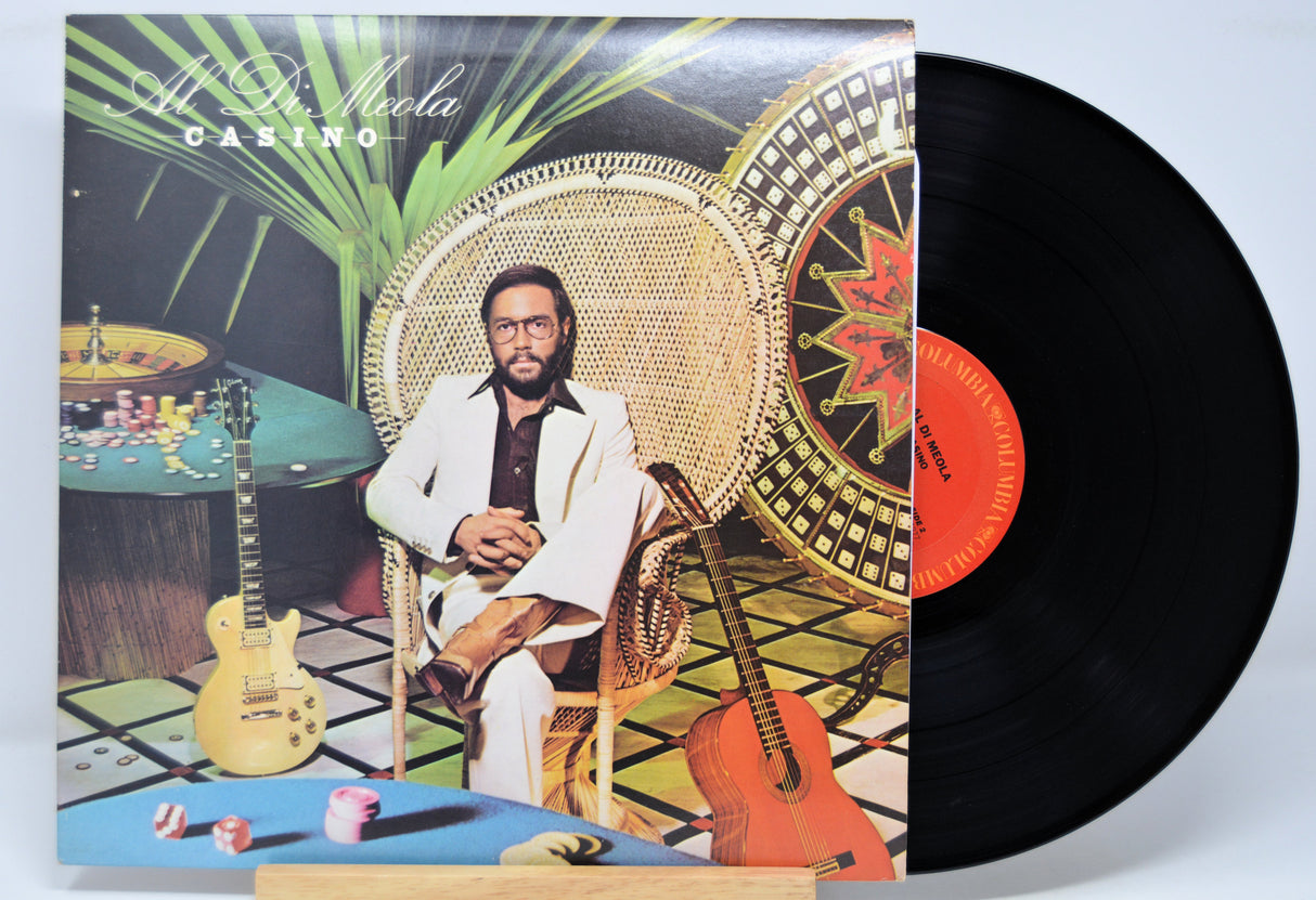 Vinyl record 'Al Di Meola Casino' with a cover featuring Al in a stylish setting, including a guitar and table.