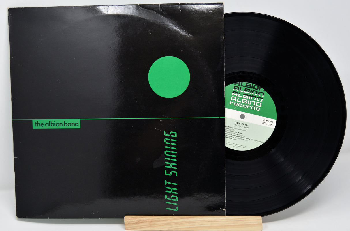 Used vinyl record of Albion Band's album 'Light Shining', with a black cover featuring a green circle and the band's name.