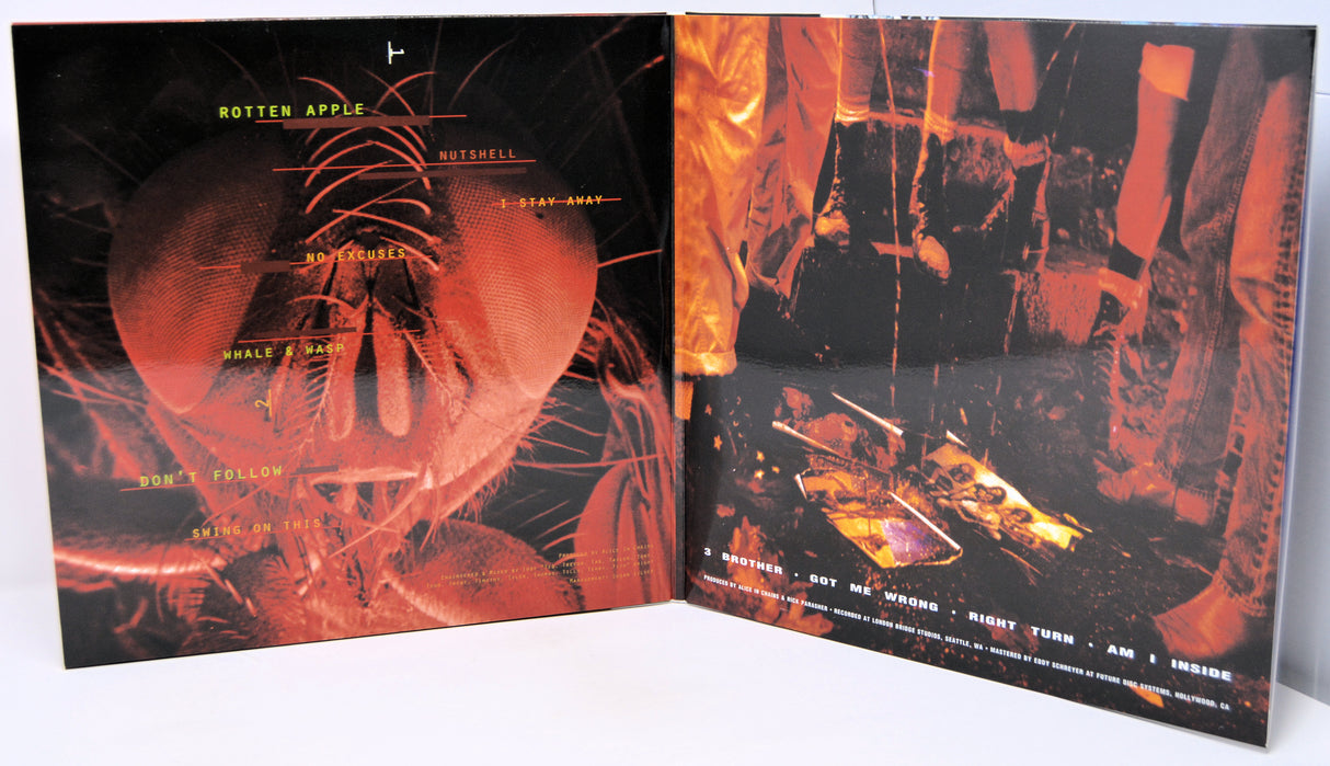 Vinyl record album shown open to reveal the front cover and inner sleeve artwork, featuring fiery red, orange, and black abstract imagery with small white text.