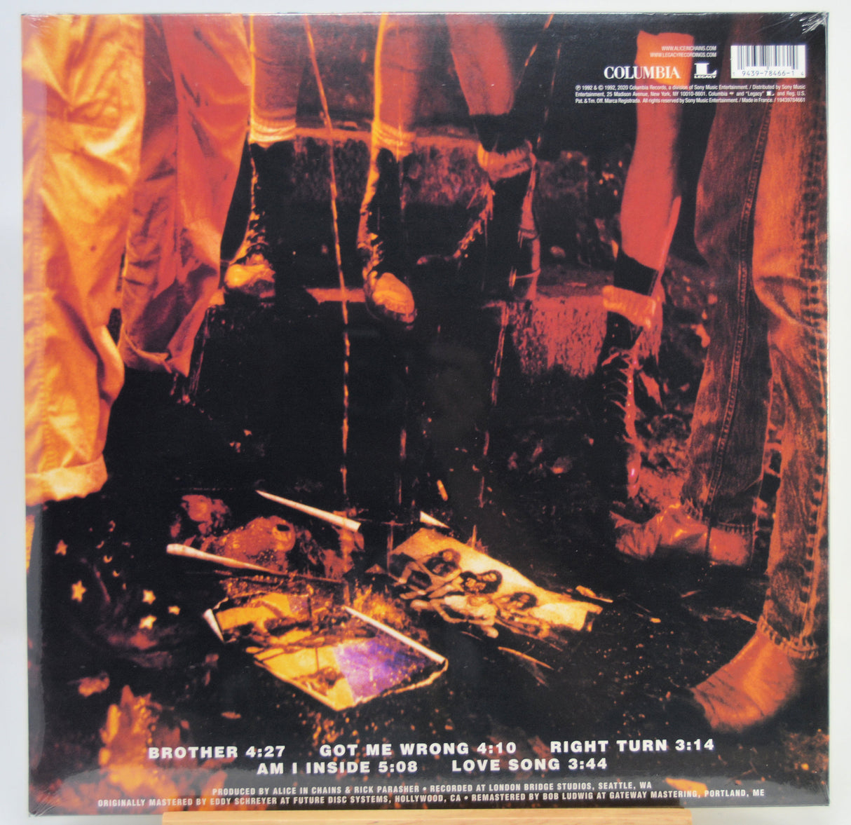 The back cover of a Columbia Records vinyl record, featuring a dark, gritty photograph with orange and yellow lighting. The tracklist is printed in white text at the bottom.