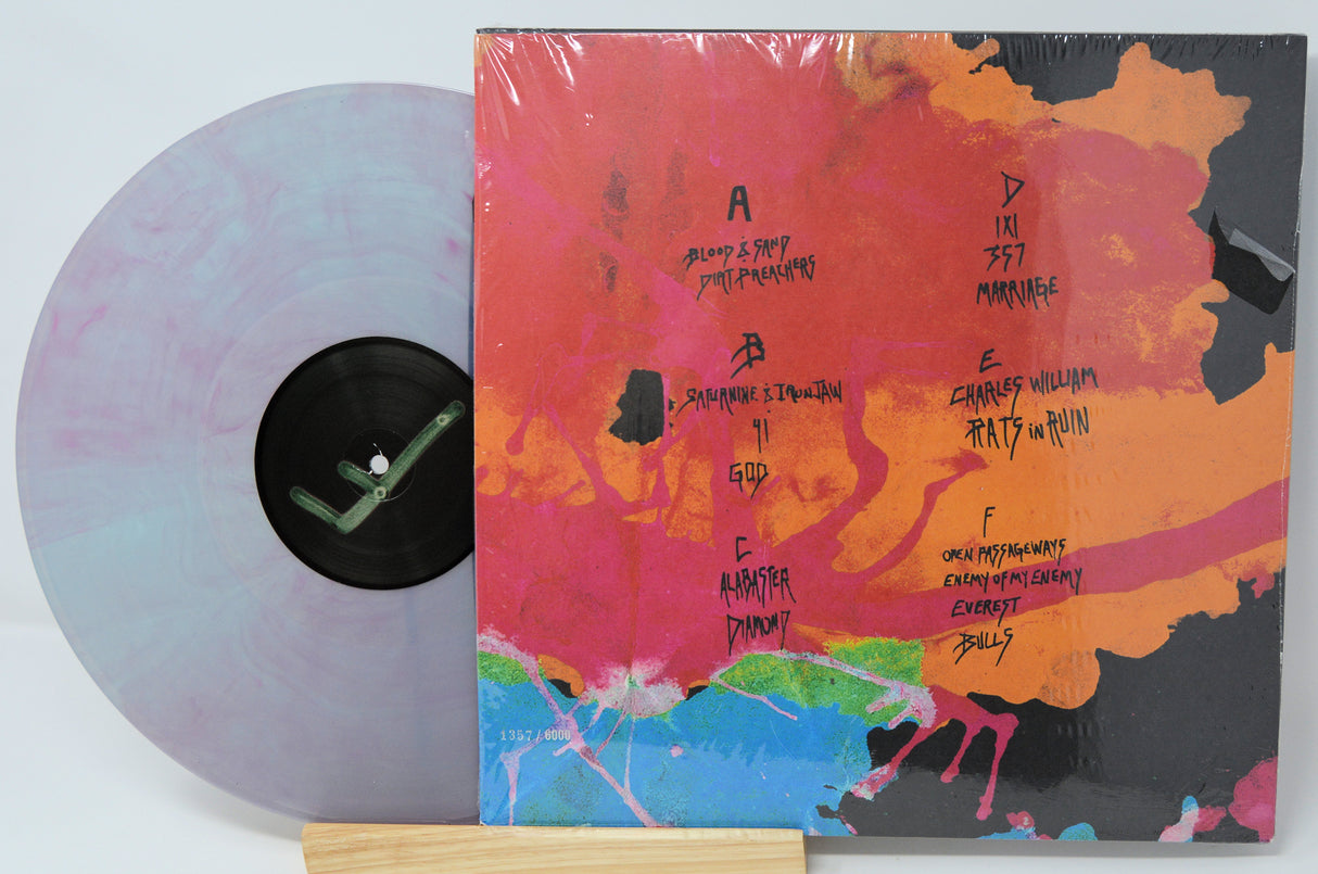 Vinyl record with a colorful cover and multicolored disc on a white background