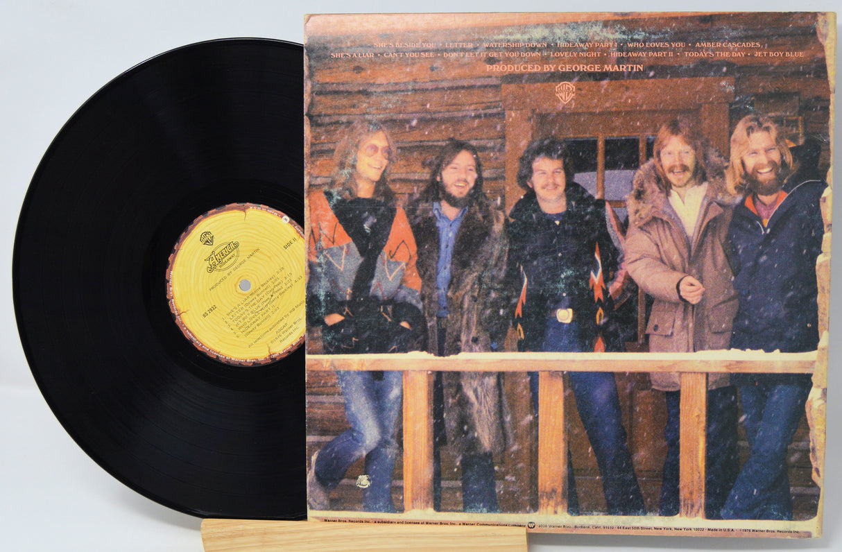 Vinyl record with a cover featuring a group of people on a wooden porch.