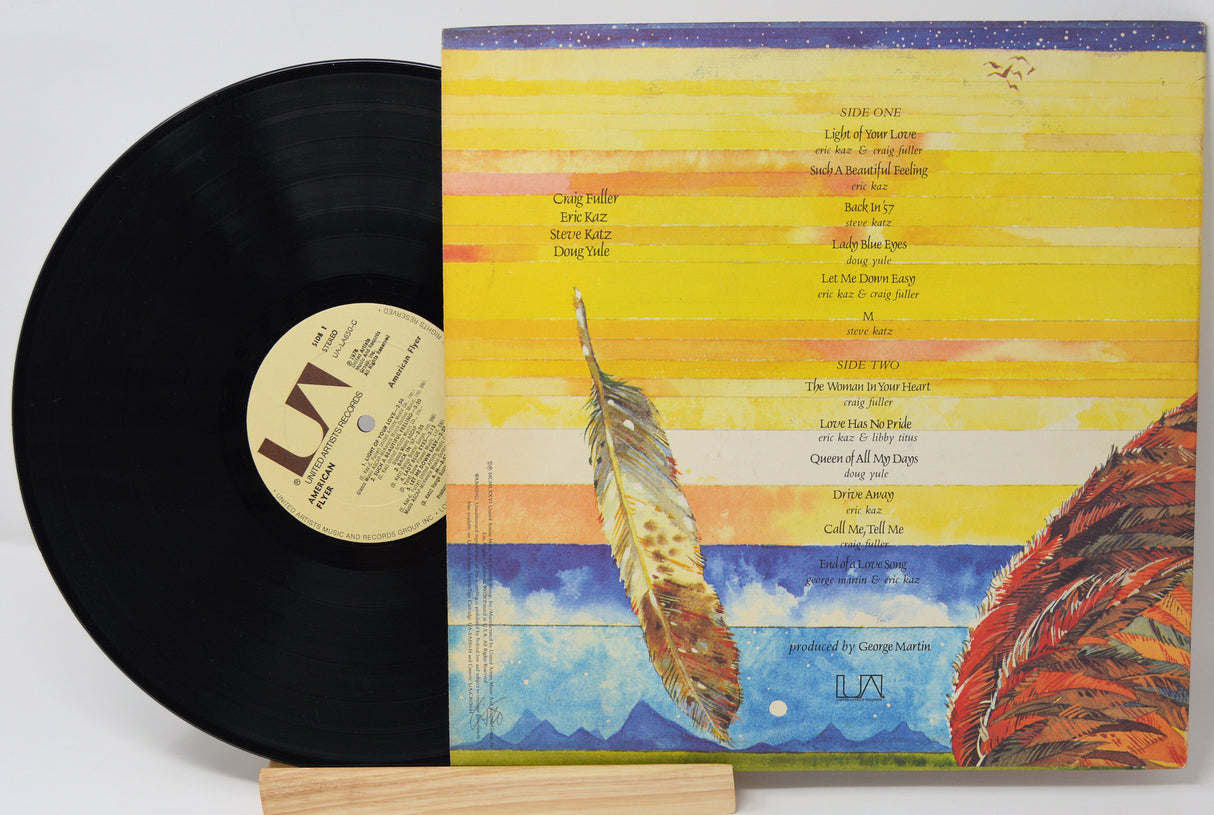 Used vinyl record of American Flyer with a yellow and blue cover featuring an eagle graphic. The record is labeled with 'RCA' and has tracklisting for 'The Loose Connection' and 'Say You'.