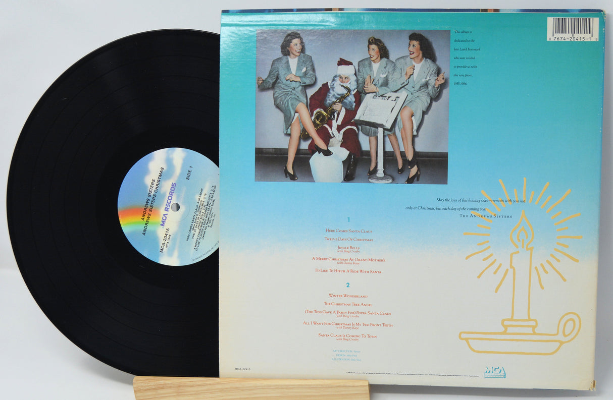 Back cover of Andrews Sisters Christmas vinyl album with retro holiday scene and tracklist