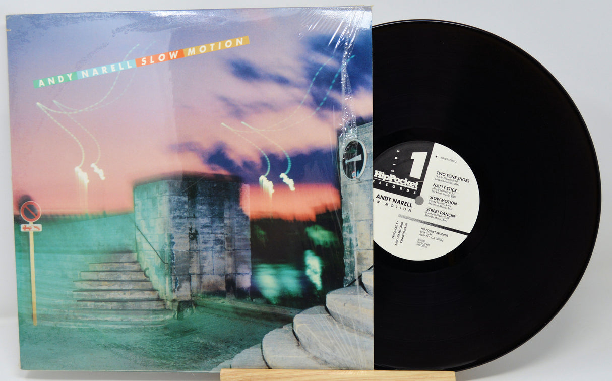 Vinyl record with cover featuring a scenic design on a white background