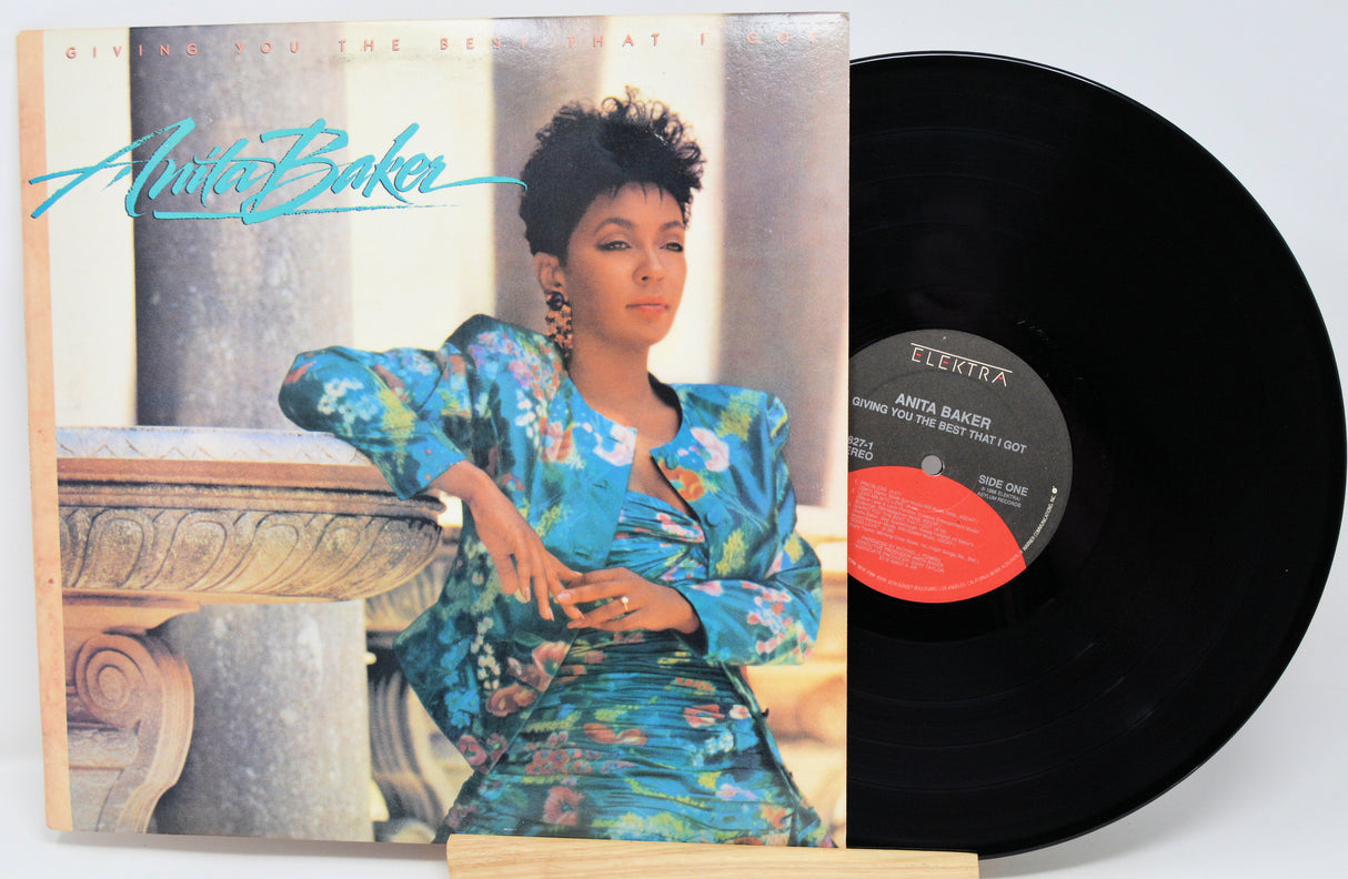 Vinyl record with cover featuring a woman in a floral dress, on a white background