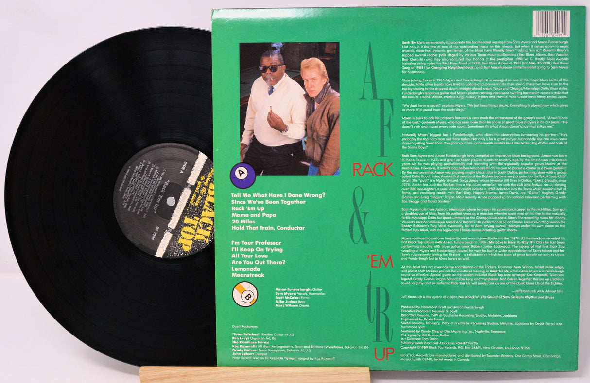 Vinyl record with green label featuring two people and text on a white background