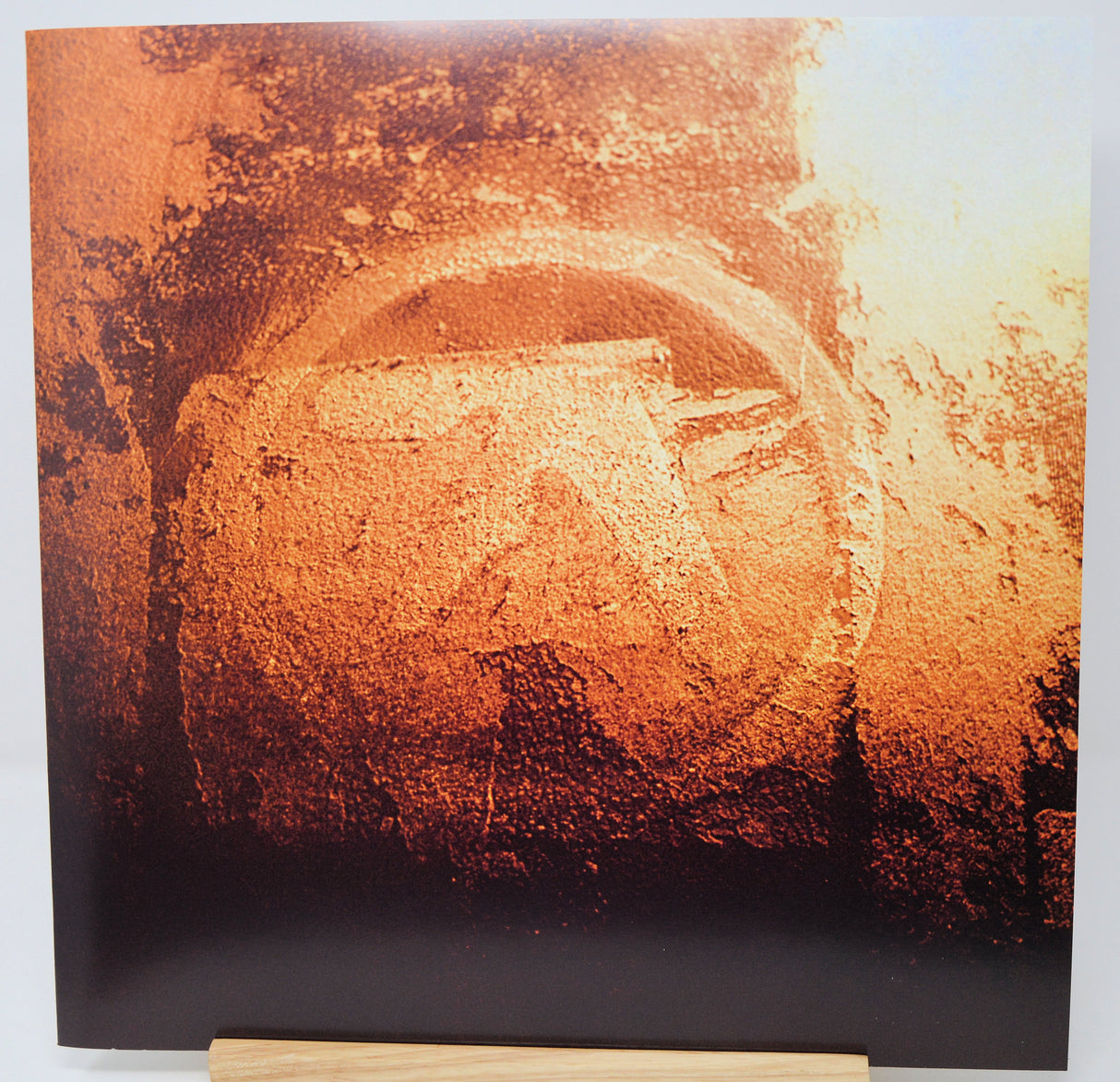 Abstract art piece with warm tones on a white background