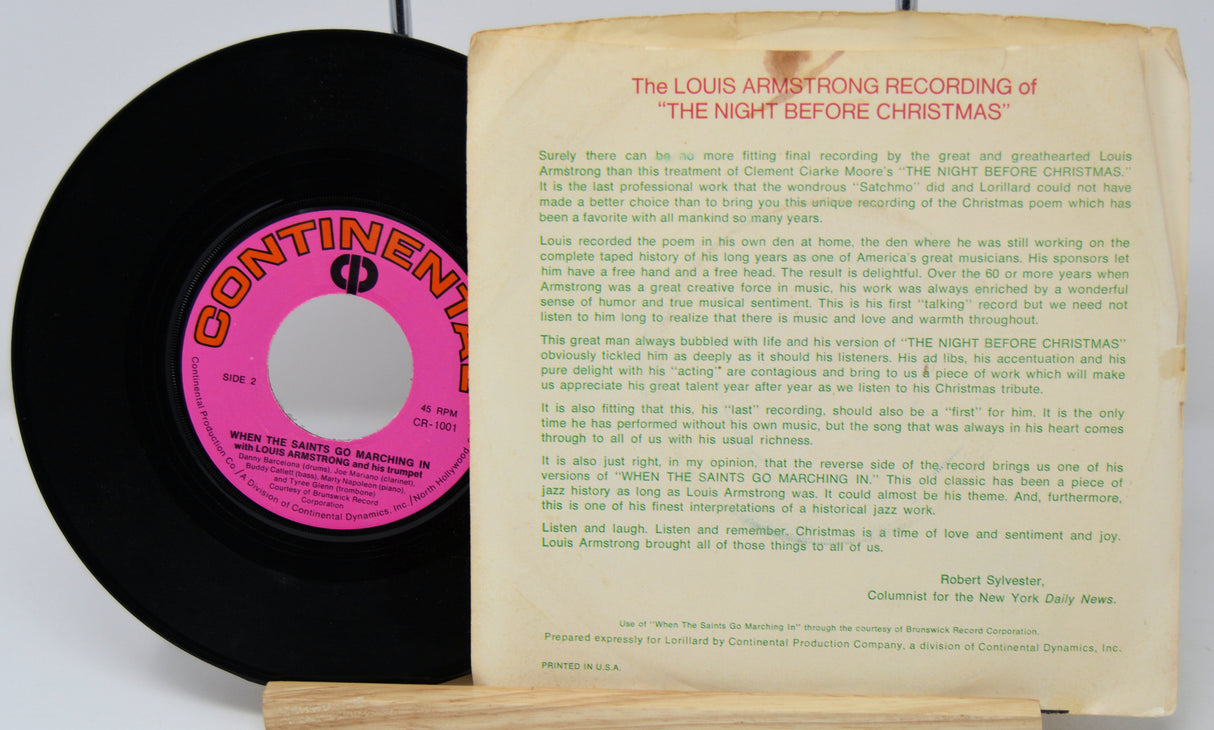 Vinyl record with pink label and record cover featuring text on a white background