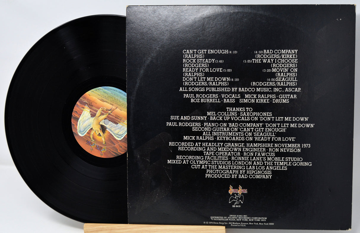 Vinyl record with cover displaying tracklist on a white background