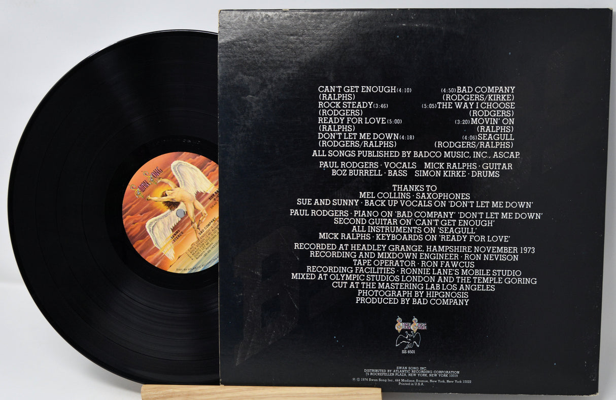 Vinyl record with cover displaying tracklist and artwork on a white background