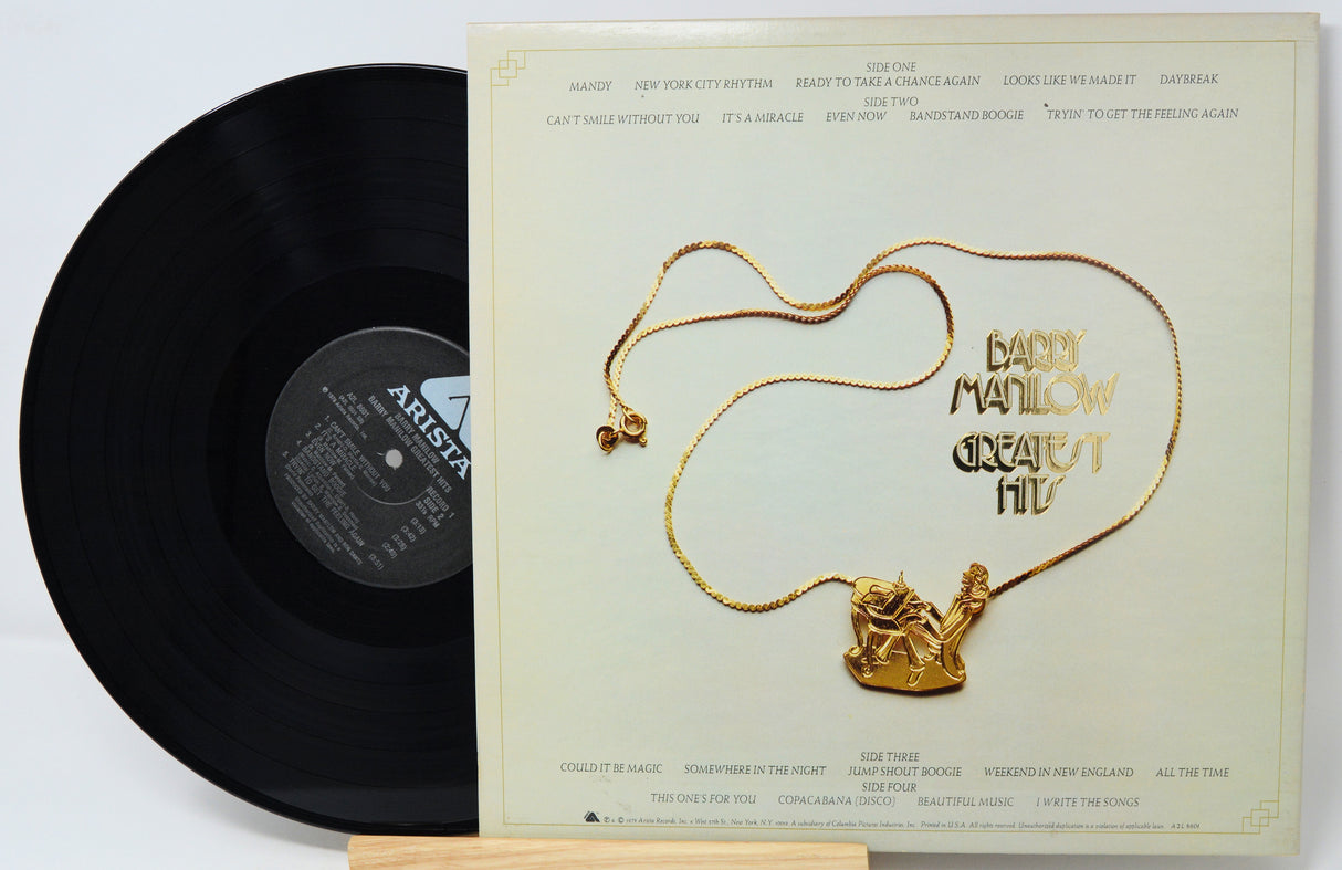 Vinyl record with a gold necklace on the cover