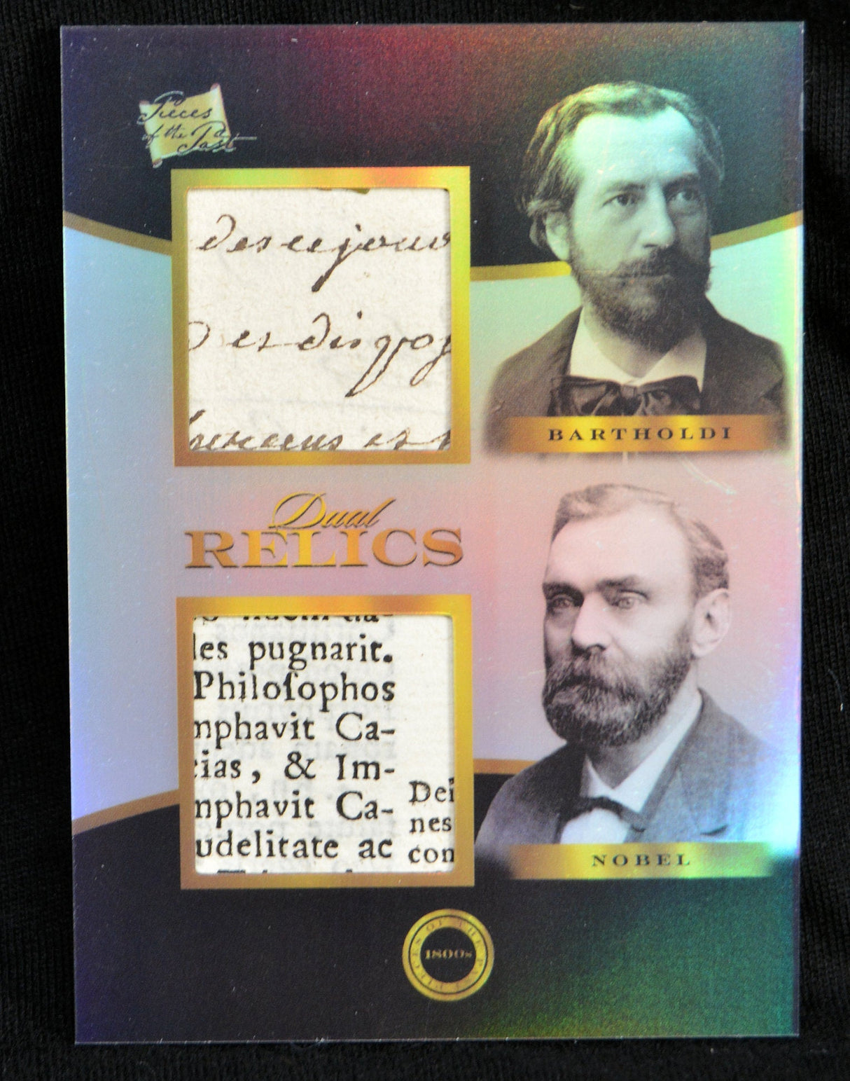 Dual Relics trading card featuring portraits of Bartholdi and Nobel with authentic manuscript and newspaper fragments