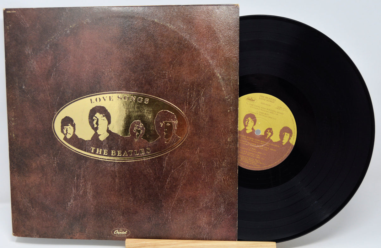 Vinyl record and cover with 'The Beatles' artwork on a white background