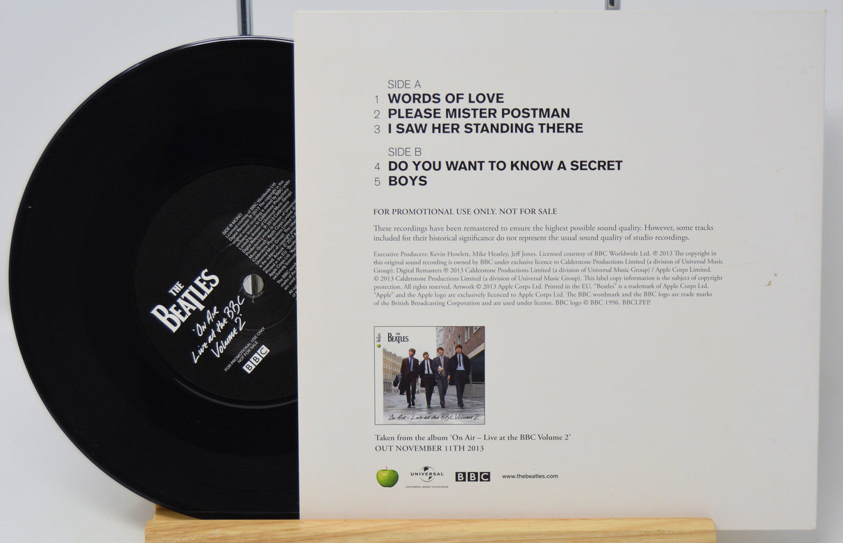 Vinyl record with cover featuring The Beatles text and image