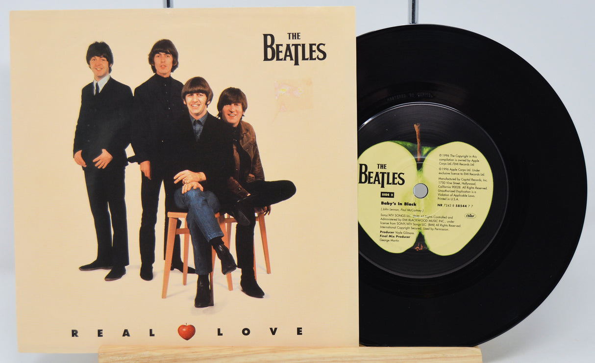 Vinyl record and cover featuring The Beatles with 'Real Love' text