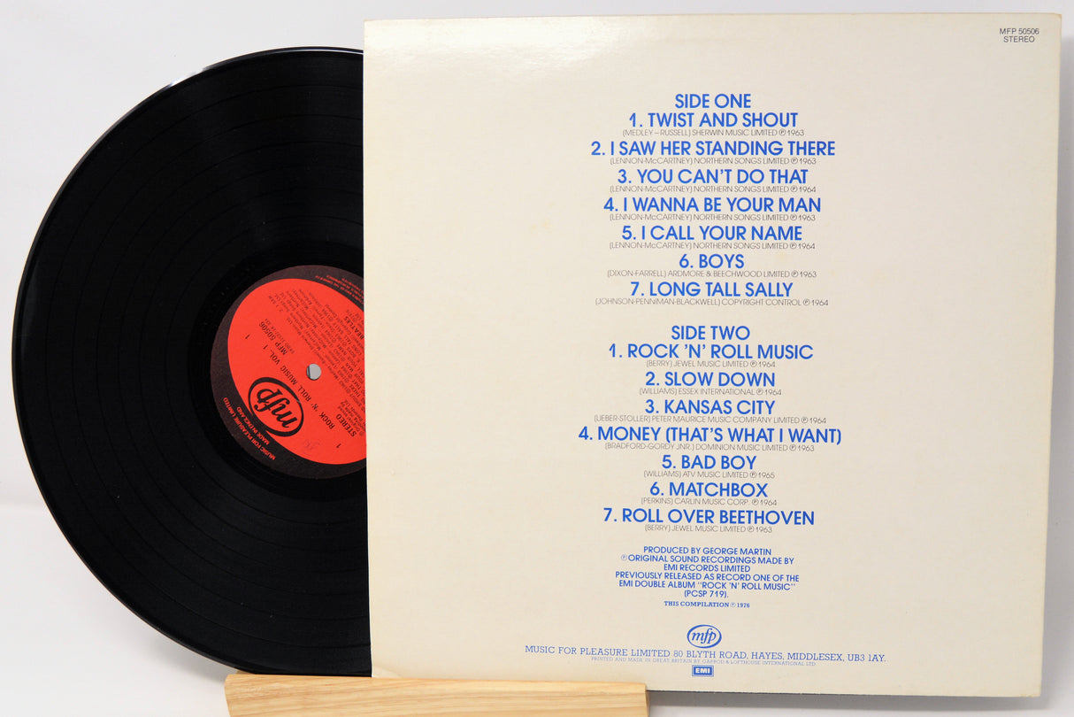 Vinyl record with sleeve displaying tracklist on a white background