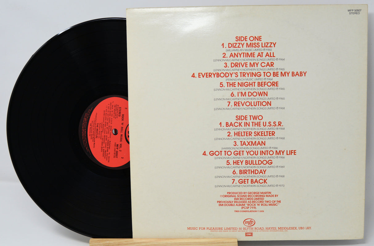 Vinyl record with red text listing track titles on a white background