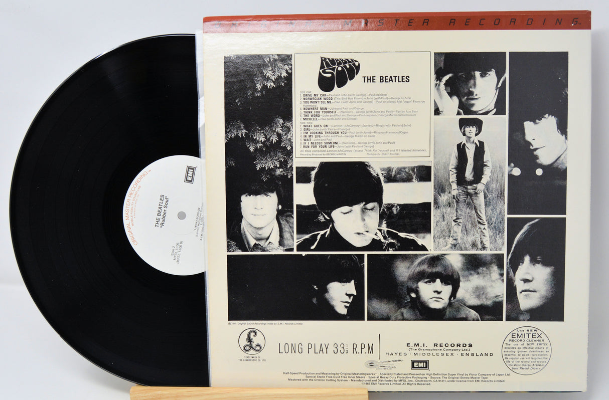 Vinyl record with cover featuring black and white images of a band member, on a light gray background.