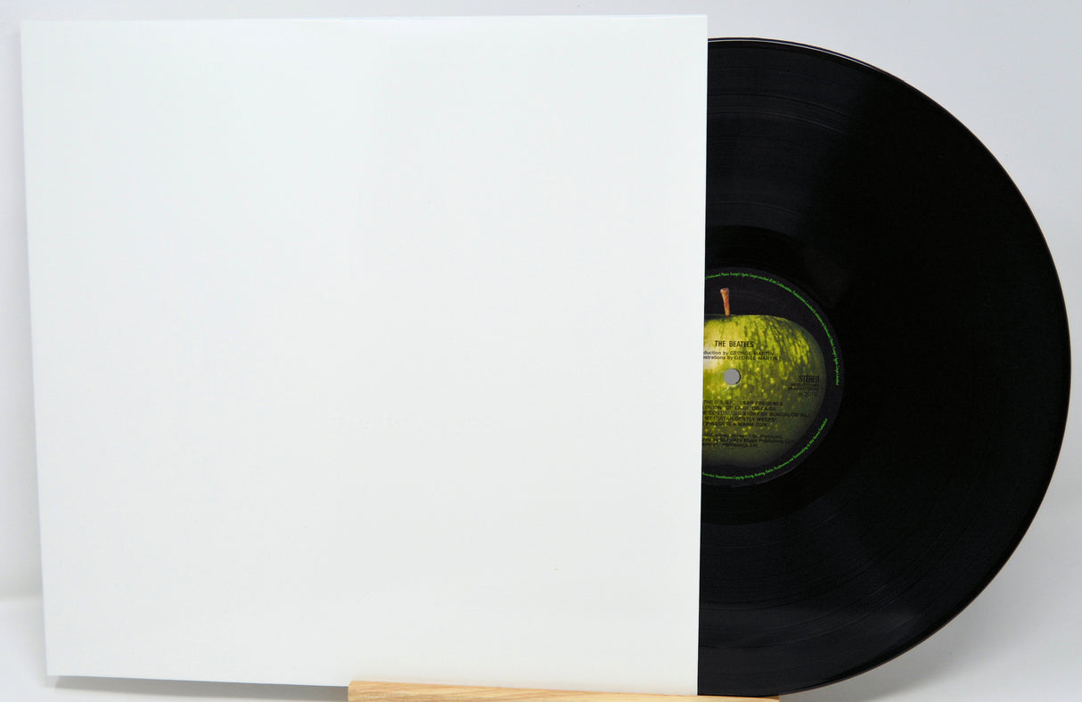 Vinyl record with a white sleeve on a light gray background