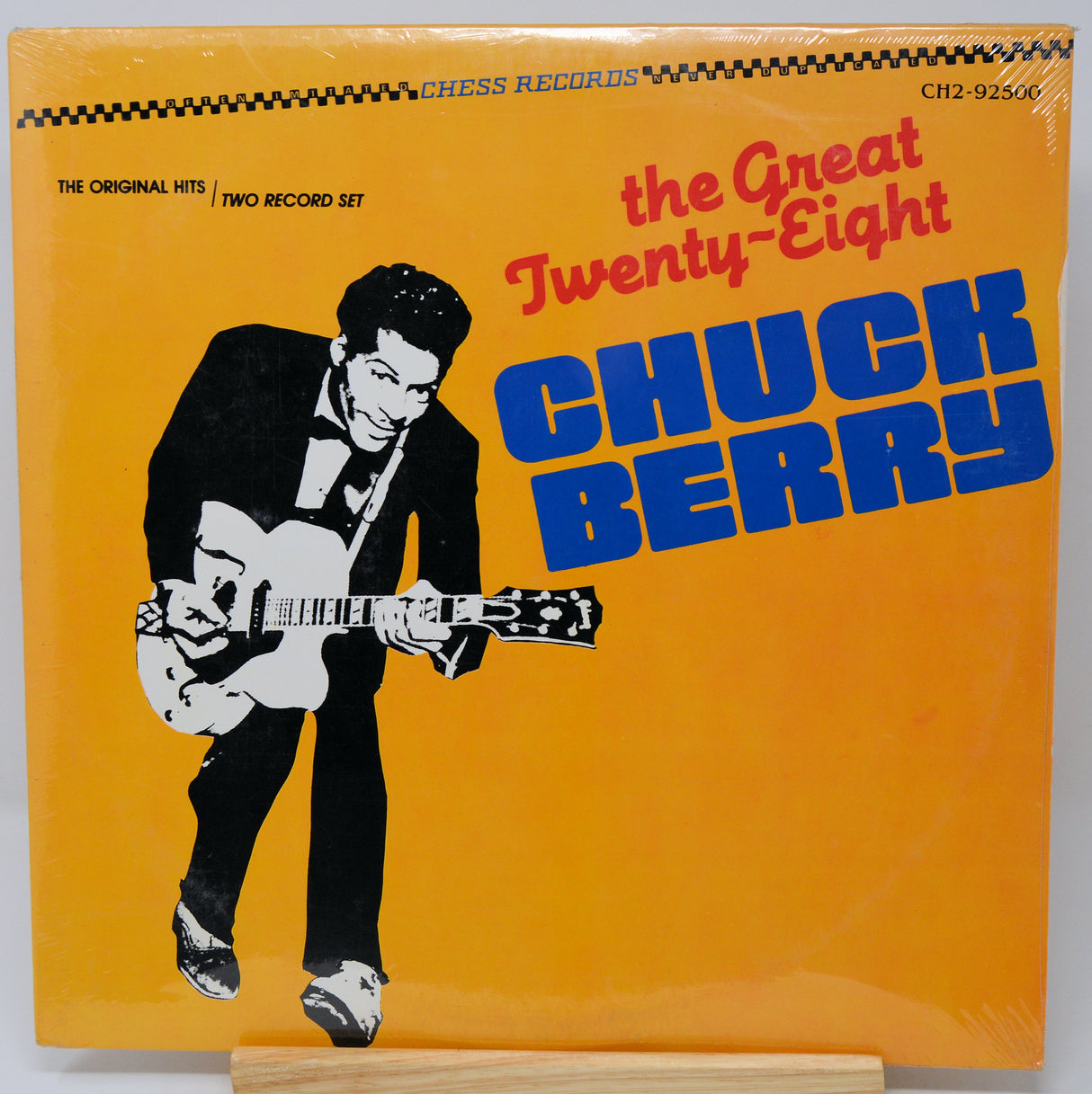 Vinyl record cover featuring a stylized illustration of a man playing guitar with 'The Great Twenty-Eight Chuck Berry' text on an orange background.