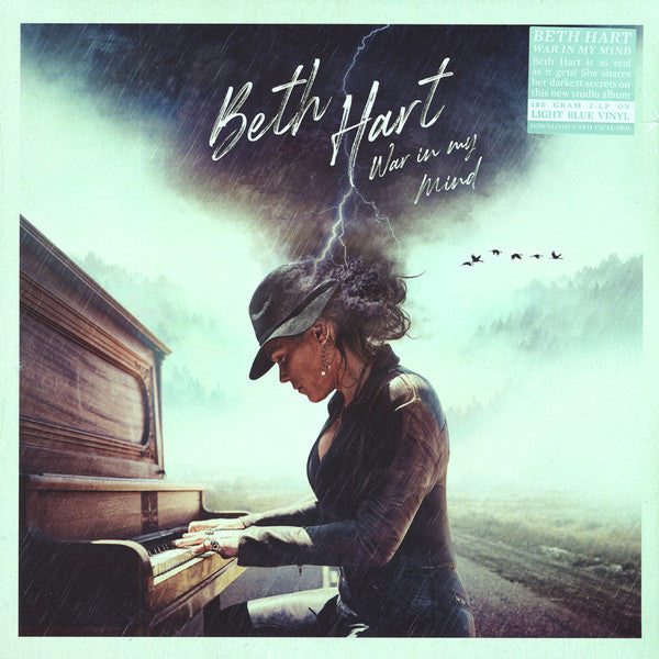 Album cover featuring a woman playing piano with a stormy background and text 'Beth Hart War in my Mind'.