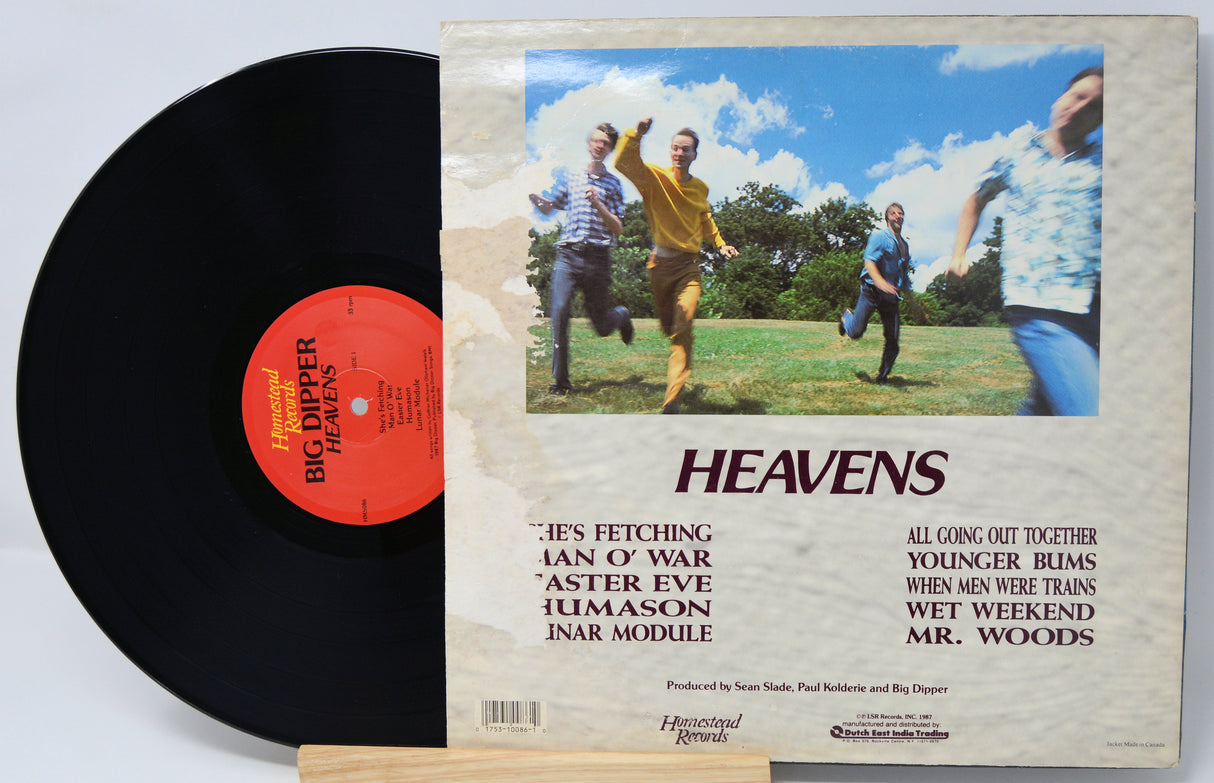 Vinyl record with a colorful cover featuring four people running, titled 'Heavens'.