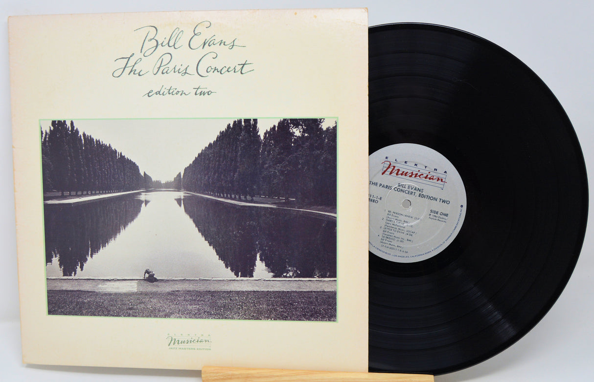 Vinyl record with a cover featuring a scenic landscape and album details.
