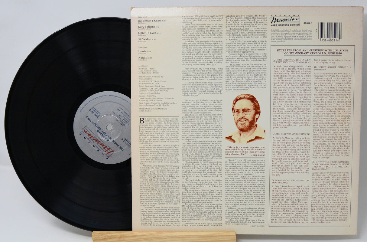 Vinyl record with a detailed cover featuring text and a portrait on a light gray background