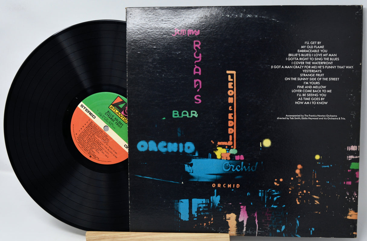 Vinyl record and cover with colorful neon signs on the cover