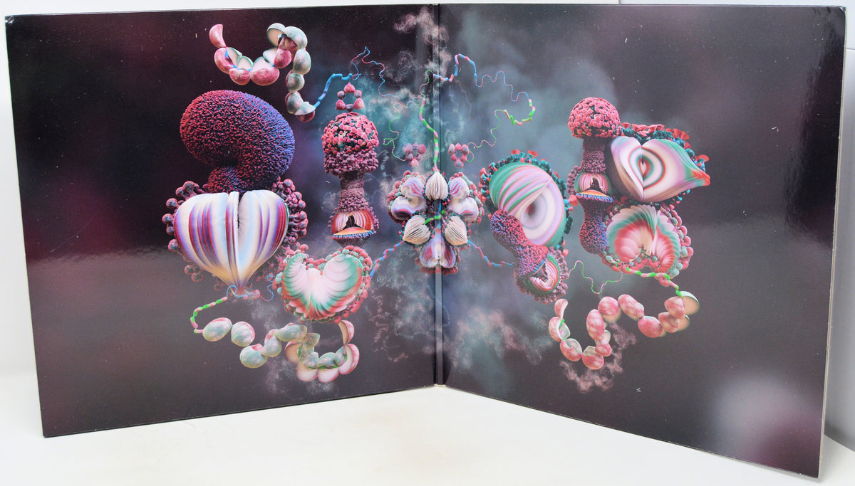 A square art print or poster displayed open against a white surface, featuring surreal abstract organic forms in pink, purple, teal, and cream on a dark background.