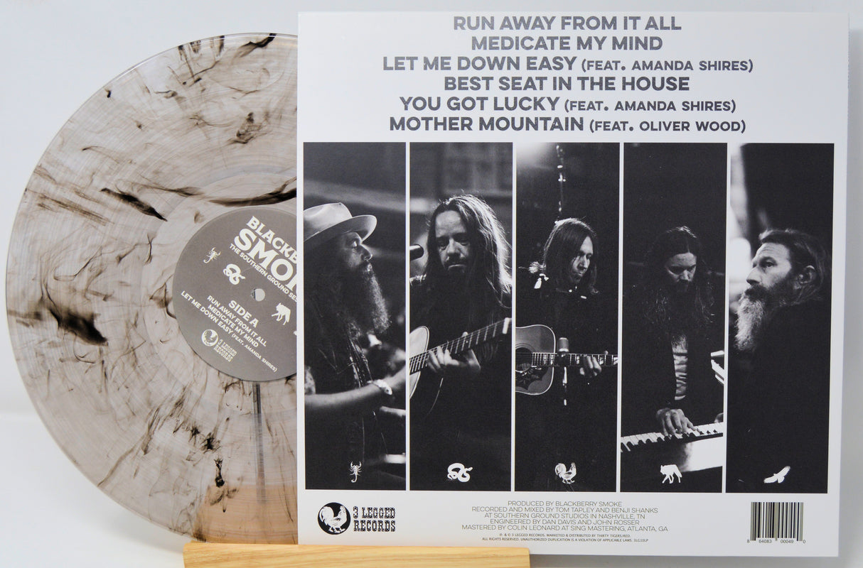 Black Smoke Records' 'Medicate My Mind' vinyl record LP shown with its back cover. The LP features a distinctive marbled, cloudy light beige and gray pattern, while the back cover displays a black-and-white band photo collage and tracklist.
