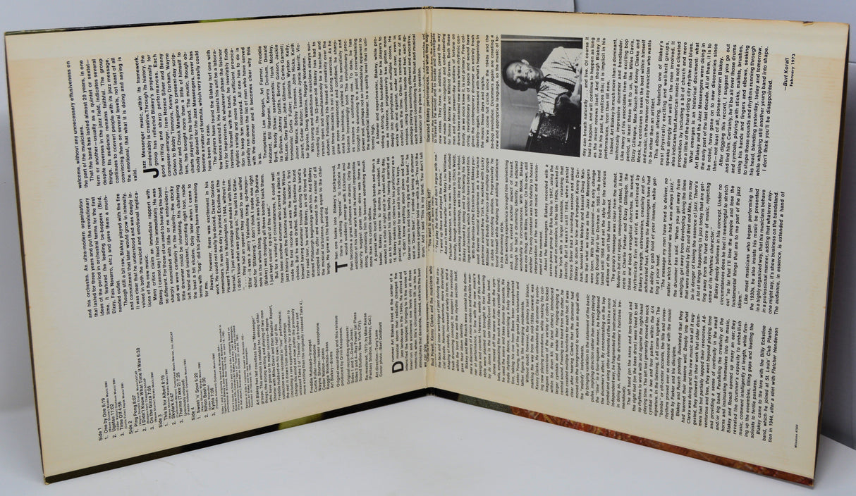 Open book with text and a portrait on a white background