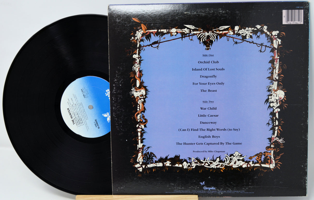 Vinyl record with a decorative cover featuring text and floral designs.