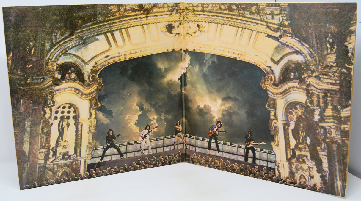 Album cover with a band performing on a bridge in front of an ornate archway